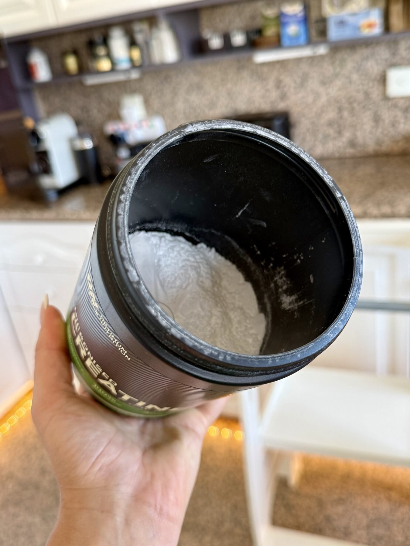 Open container of Optimum Nutrition Creatine Monohydrate showing the fine white powder inside