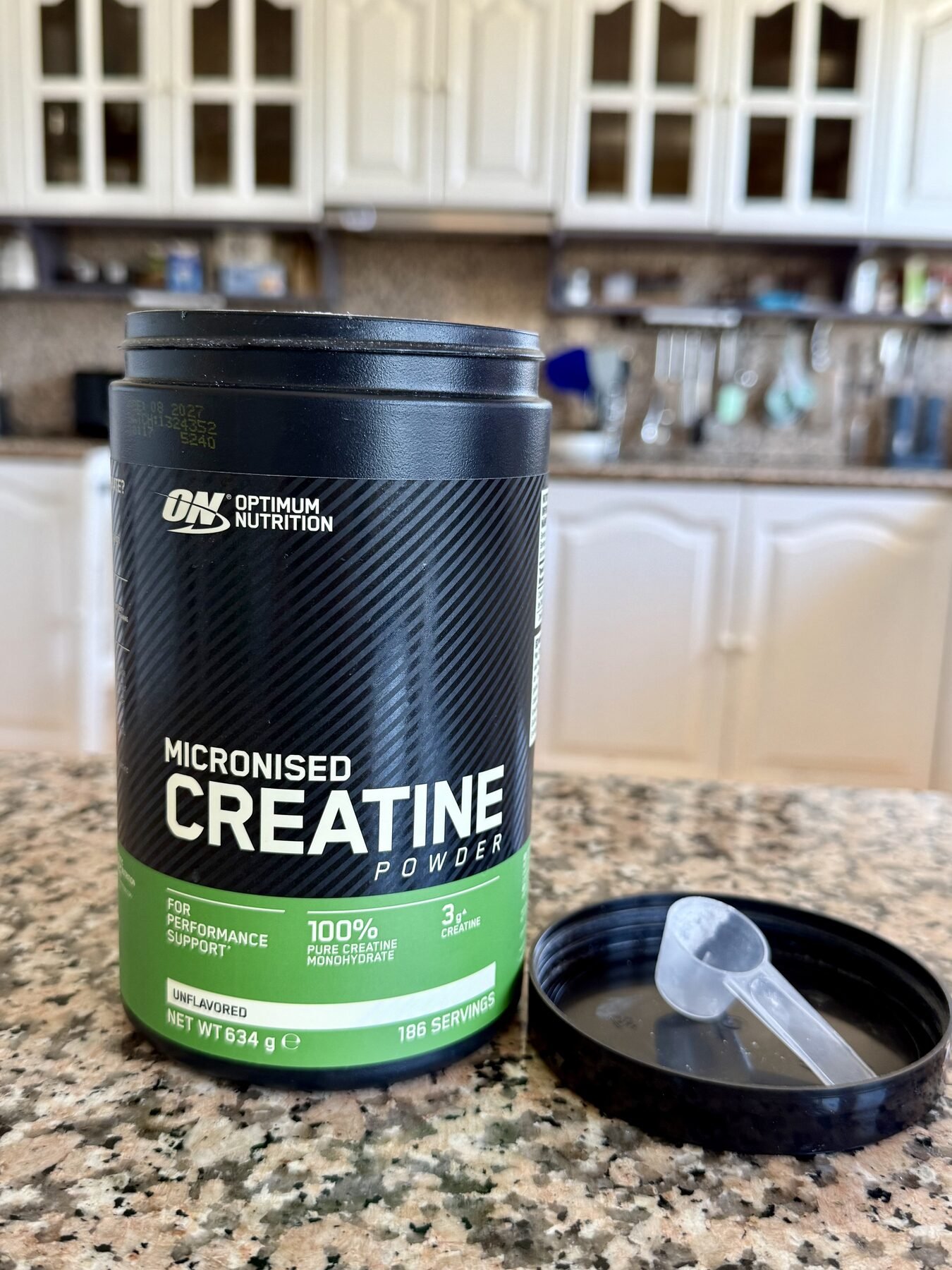 Front of Optimum Nutrition Micronized Creatine Monohydrate container with included measuring scoop.